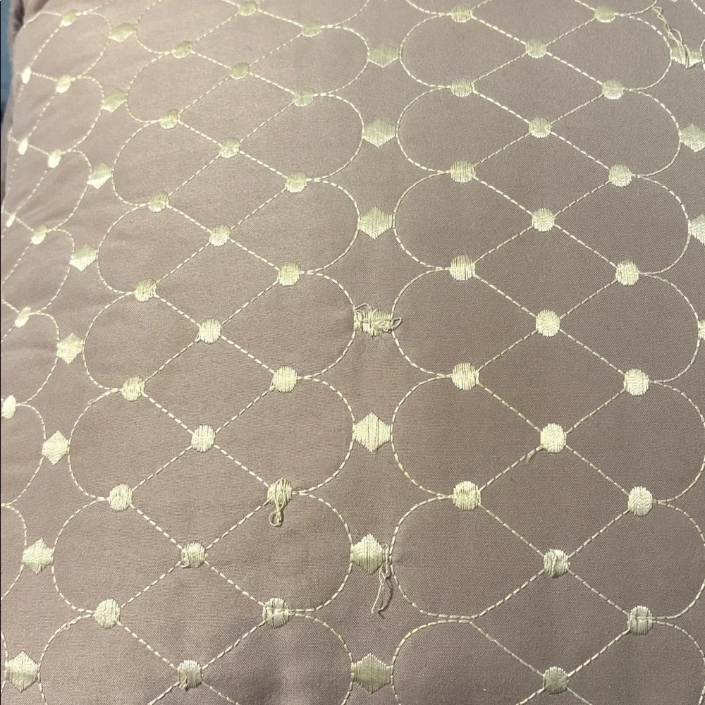 Mauve Quilted Throw Pillow square with some loose strings.
